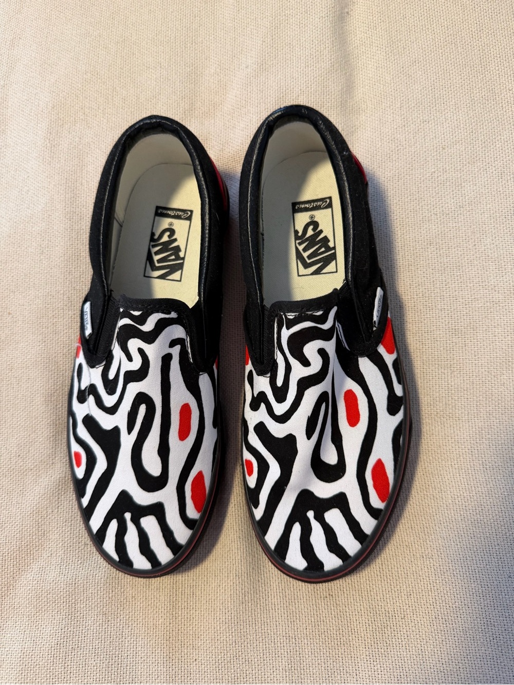 Vans Slip-On Shoes in Black, White & Red Abstract Pattern